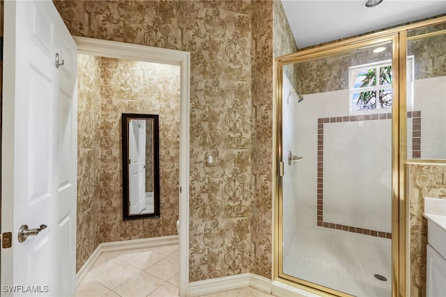 bathroom with walk in shower, vanity, and tile patterned floors