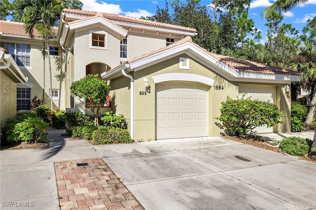 mediterranean / spanish home featuring a garage