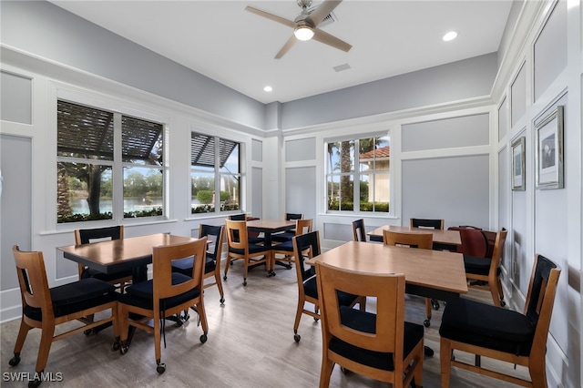 dining area with hardwood / wood-style floors and ceiling fan