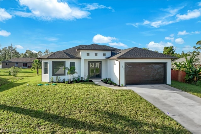 view of front facade with a garage and a front lawn