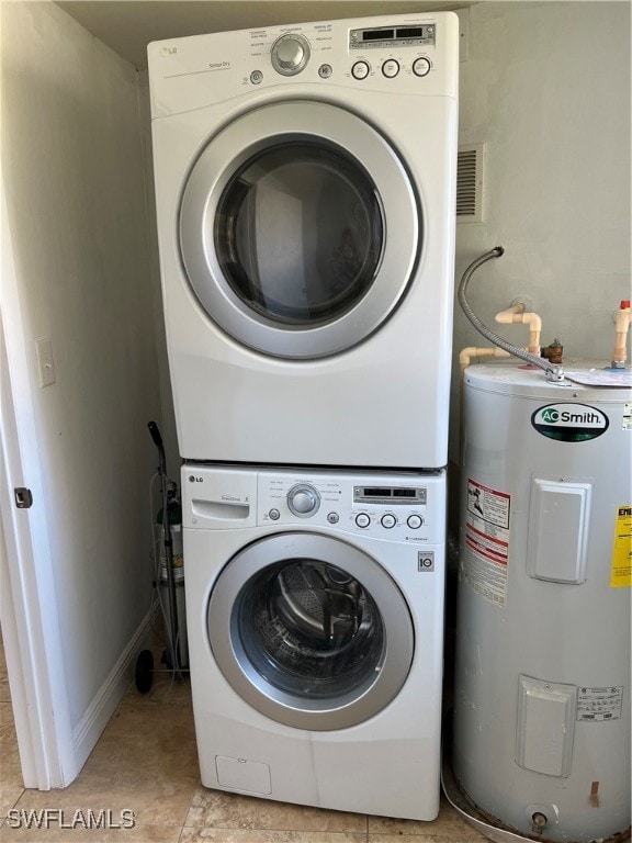 washroom with stacked washing maching and dryer, water heater, and light tile patterned floors