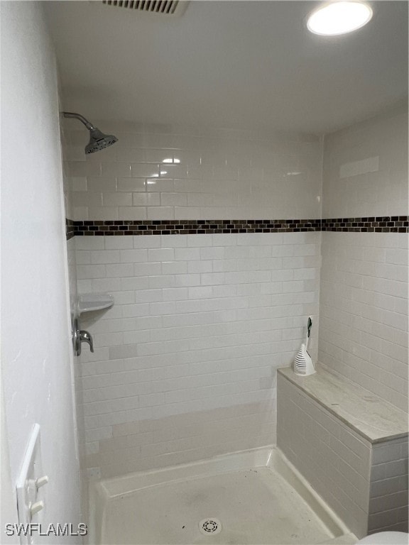 bathroom with a tile shower