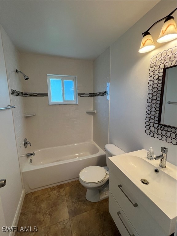 full bathroom with vanity, tiled shower / bath combo, and toilet