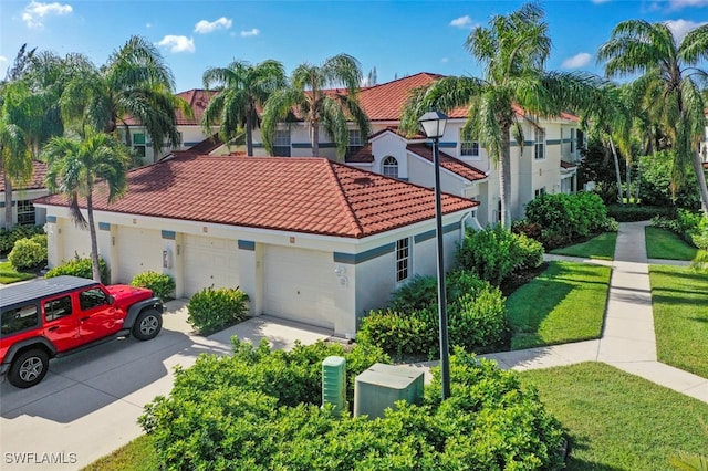 mediterranean / spanish house with a front lawn and a garage