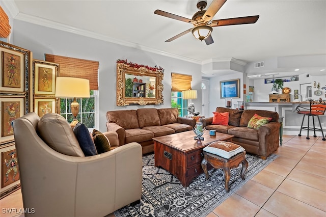 living room with crown molding, light tile patterned flooring, and ceiling fan