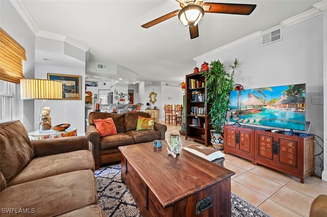 living room featuring ceiling fan, ornamental molding, and light tile patterned floors