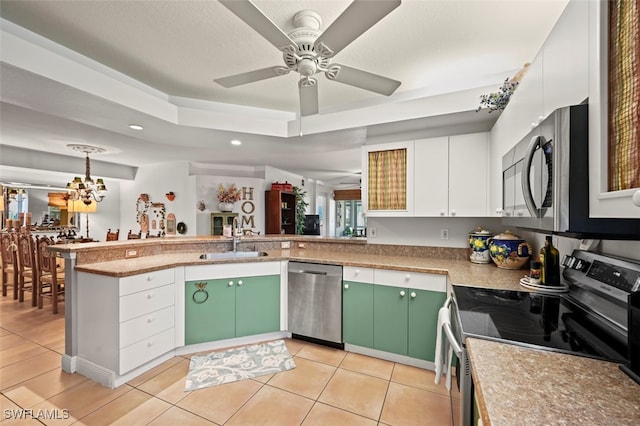 kitchen featuring white cabinets, light tile patterned floors, stainless steel appliances, sink, and green cabinets