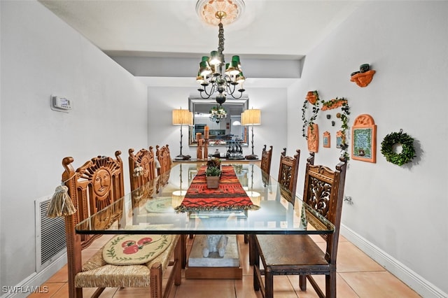 tiled dining space featuring a chandelier