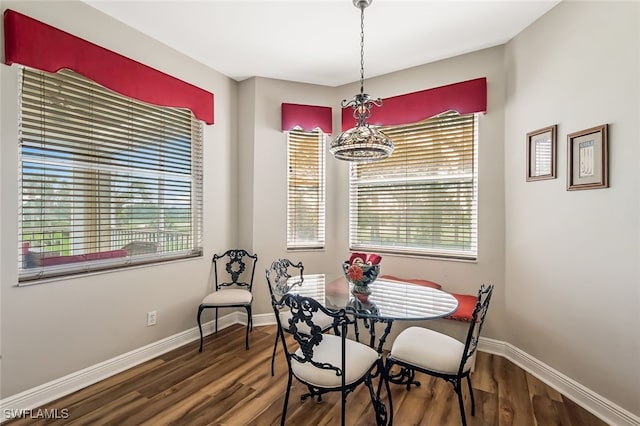 dining area featuring hardwood / wood-style flooring and a chandelier