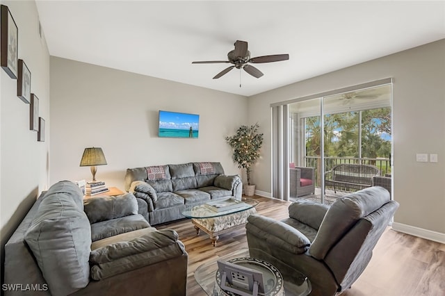 living room featuring light hardwood / wood-style floors and ceiling fan