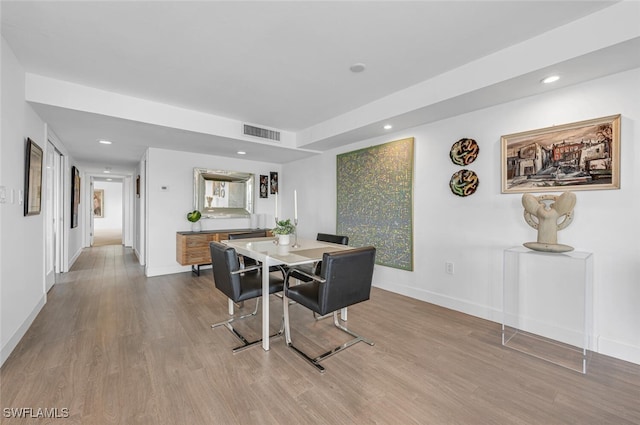 dining space with light hardwood / wood-style floors