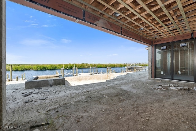 view of patio / terrace featuring a water view and a dock