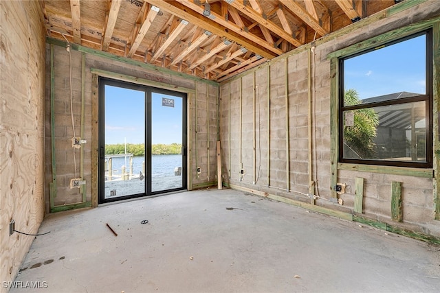 miscellaneous room featuring concrete flooring and a water view