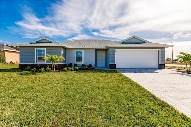 single story home featuring decorative driveway, an attached garage, stucco siding, and a front yard