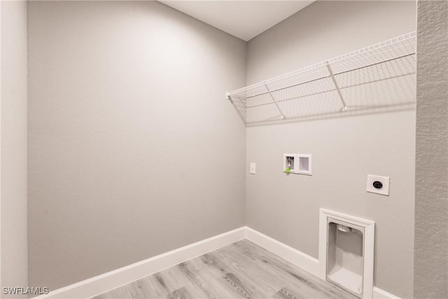 washroom with laundry area, washer hookup, light wood-style floors, baseboards, and electric dryer hookup