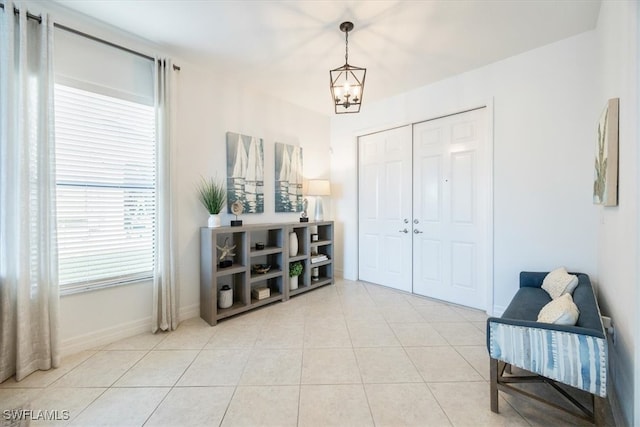 entryway with a chandelier and light tile patterned floors