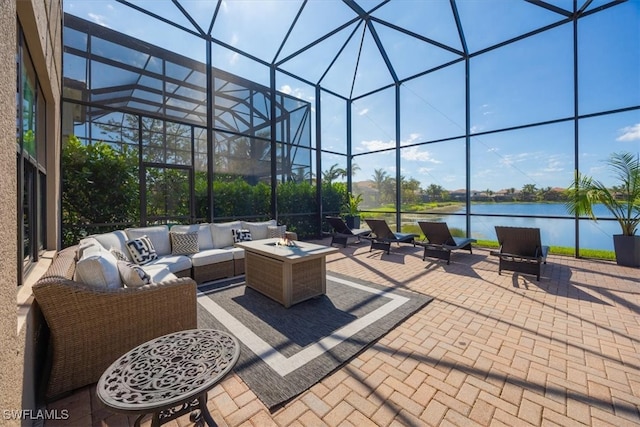 view of patio / terrace with a water view, an outdoor living space, and glass enclosure