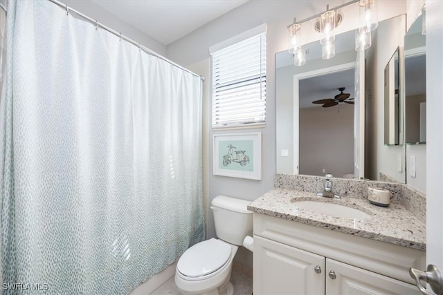 bathroom featuring walk in shower, vanity, toilet, and ceiling fan