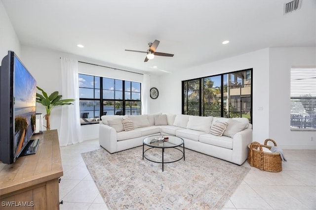 tiled living room featuring ceiling fan