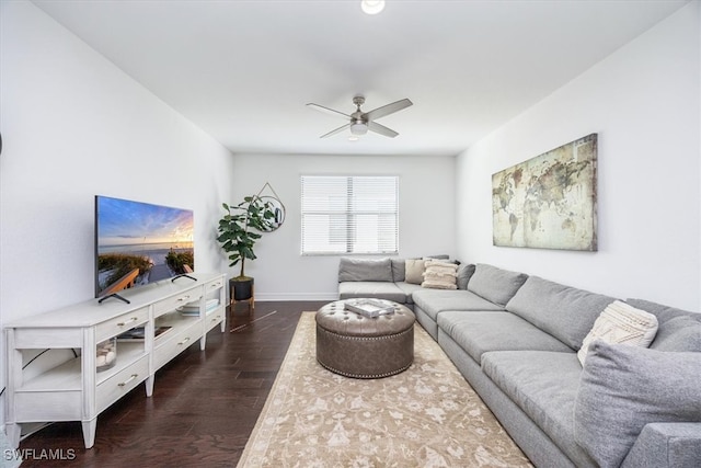 living room featuring ceiling fan and dark hardwood / wood-style flooring