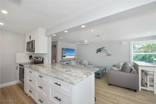 kitchen with ceiling fan, light hardwood / wood-style flooring, white cabinets, and appliances with stainless steel finishes