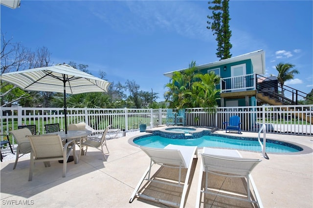 view of swimming pool featuring an in ground hot tub and a patio