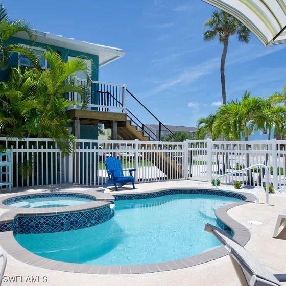 view of swimming pool featuring an in ground hot tub