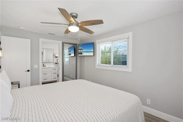 bedroom with ceiling fan, hardwood / wood-style floors, and sink