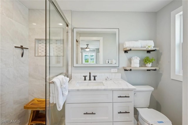 bathroom featuring vanity, ceiling fan, toilet, and walk in shower