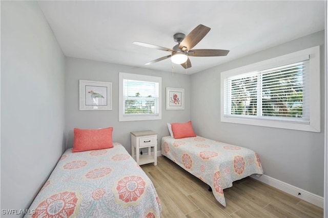 bedroom with light hardwood / wood-style flooring and ceiling fan