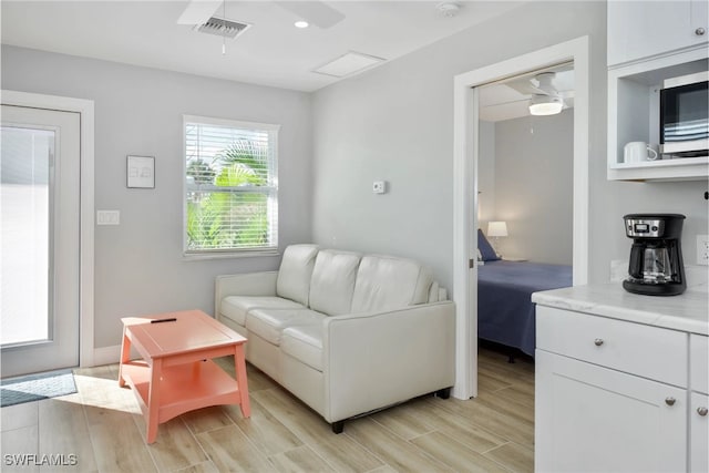 sitting room with ceiling fan and light hardwood / wood-style floors