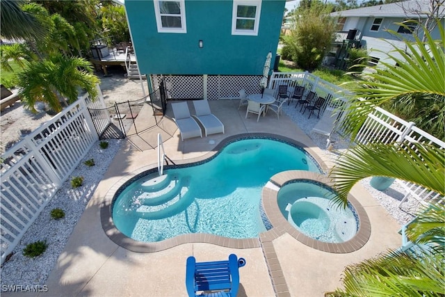 view of swimming pool with an in ground hot tub and a patio