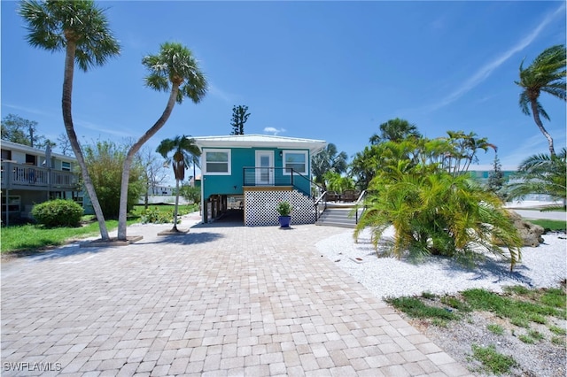 coastal inspired home featuring a carport