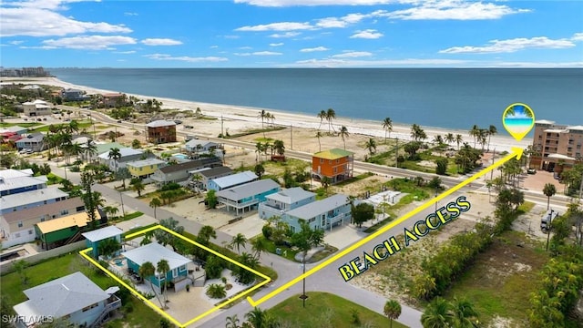 bird's eye view featuring a water view and a view of the beach