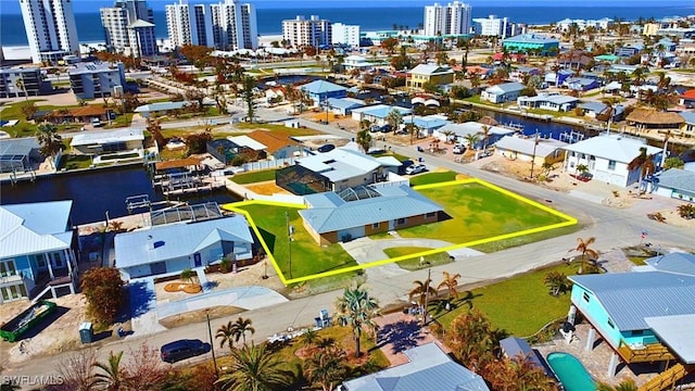 drone / aerial view featuring a water view and a city view