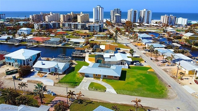 drone / aerial view featuring a view of city and a water view