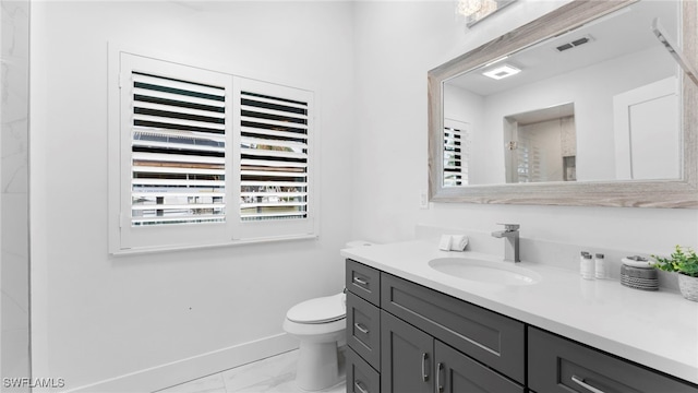 bathroom with toilet and vanity