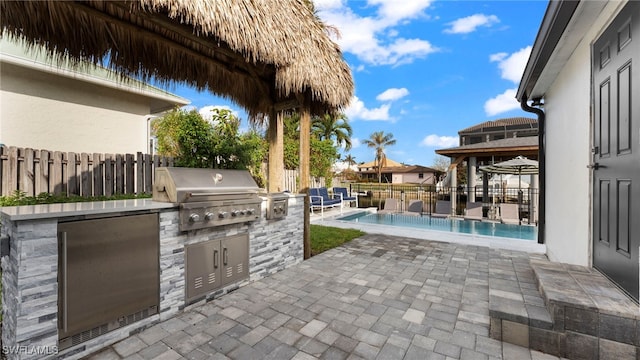 view of patio featuring grilling area, a fenced in pool, and area for grilling