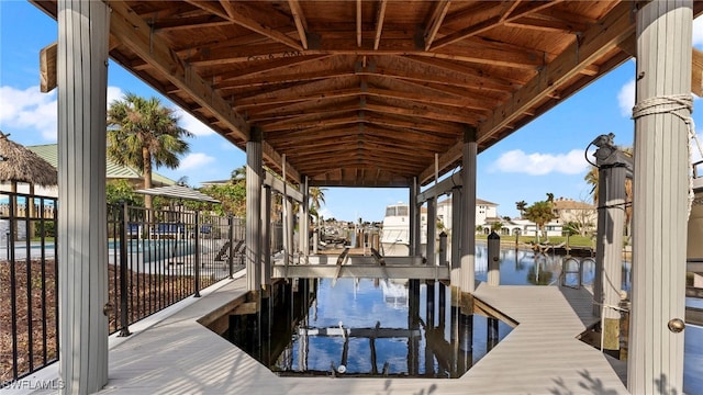 view of dock featuring a water view and a community pool