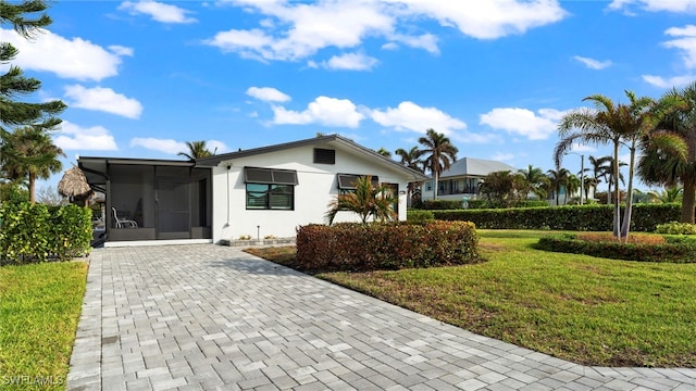 view of front of house featuring a front yard and a sunroom