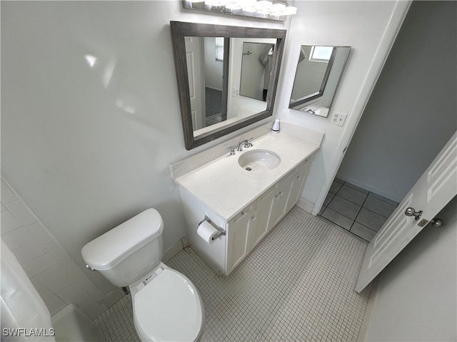 bathroom featuring vanity, toilet, and tile patterned flooring