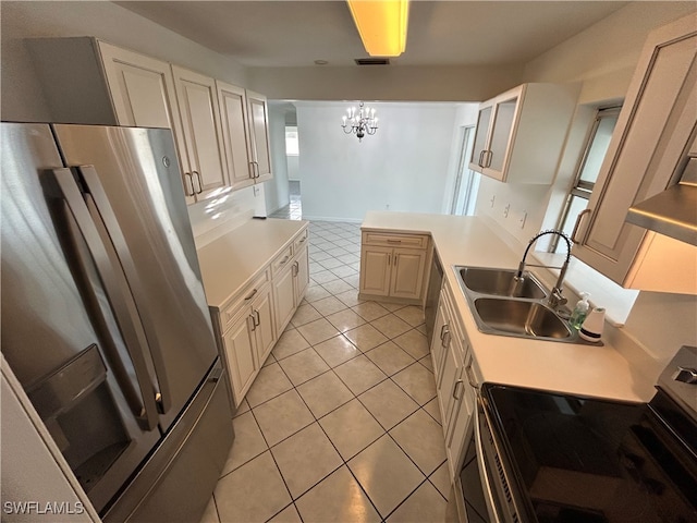 kitchen featuring sink, light tile patterned flooring, stainless steel appliances, decorative light fixtures, and a notable chandelier