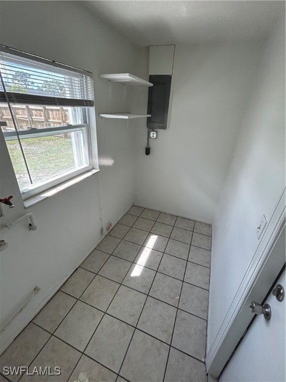 tiled empty room featuring electric panel