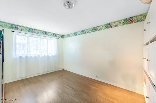 unfurnished room with light wood-type flooring