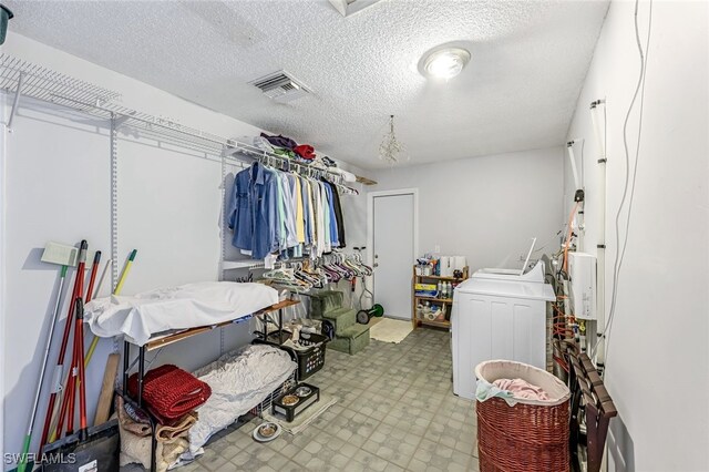 walk in closet featuring washing machine and clothes dryer