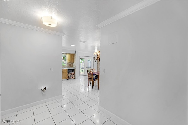 corridor with french doors, crown molding, a textured ceiling, and light tile patterned flooring