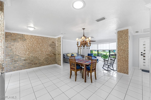 dining area with an inviting chandelier, ornamental molding, brick wall, and light tile patterned floors