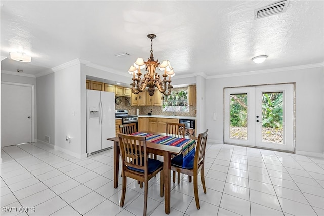 dining space with light tile patterned flooring, french doors, a textured ceiling, crown molding, and a notable chandelier