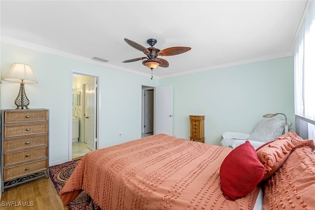 bedroom featuring crown molding, ensuite bathroom, wood-type flooring, and ceiling fan