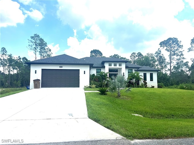 view of front of home featuring a front lawn and a garage